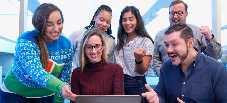 A team of in-house marketers smiling because of a campaign they made.