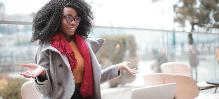 Surprised woman looking at a laptop and researching best names for rehab centers