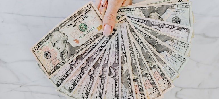 A person holding dollar bills