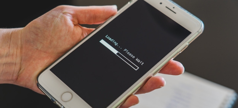 Person holding an iPhone that's loading
