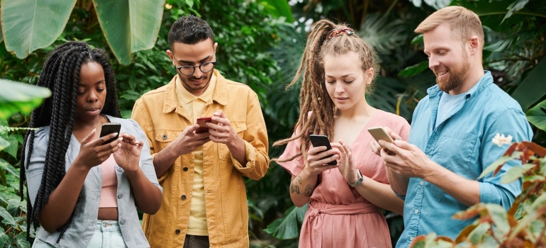 Group of people using their phones to research Google Maps marketing tactics