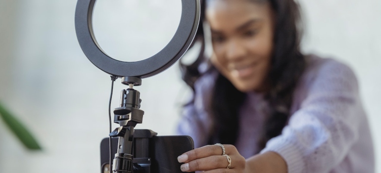Influencer setting up lights before recording a video