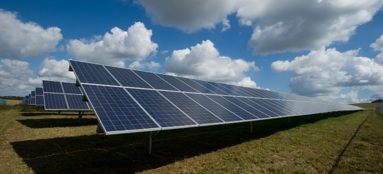 Large solar panels in a filed during a cloudy day