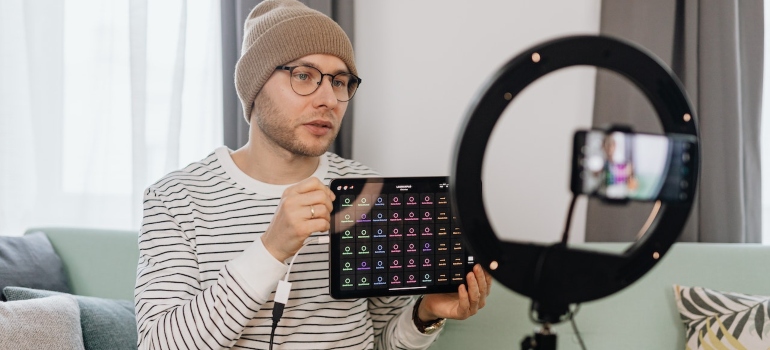 Person recording a vlog and showing charts on their tablet