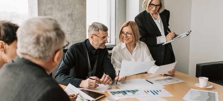 People in an office reading reviews and talking