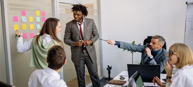 Diverse marketing team having a meeting in an office and trying to choose between a digital marketing agency and freelance marketers