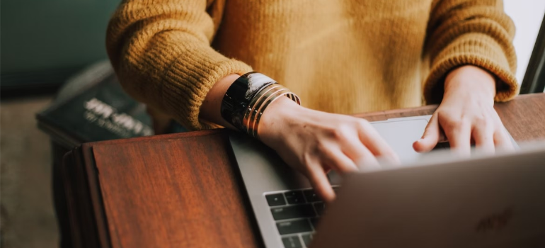 A close-up of a woman browsing the internet on a laptop, illustrating the importance of online reviews and building trust.