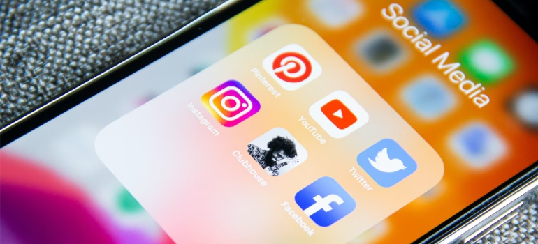 A close-up of social media app icons on a smartphone screen.