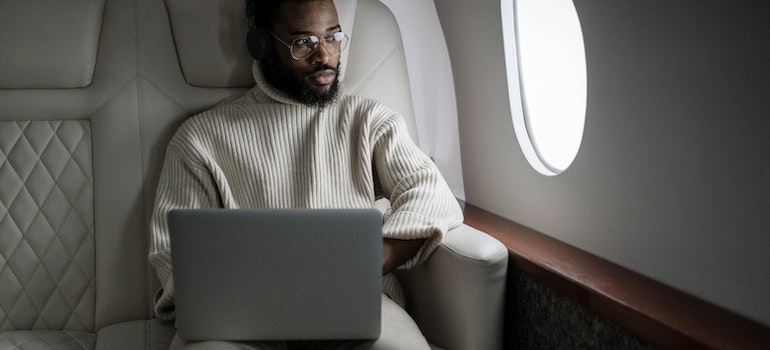 A person using a laptop in an airplane
