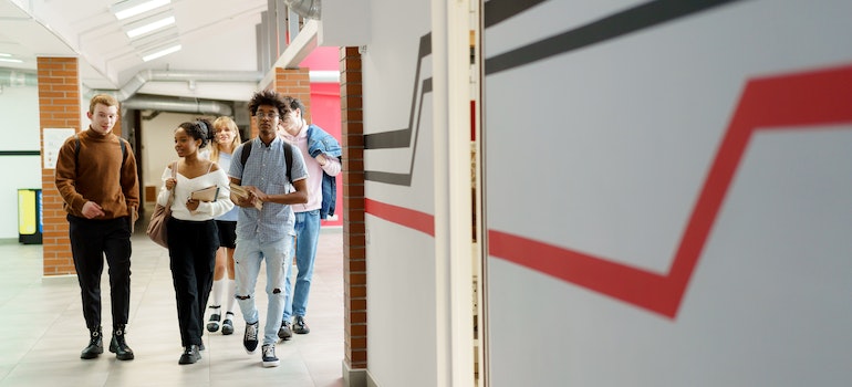Students walking in the hallway of a college