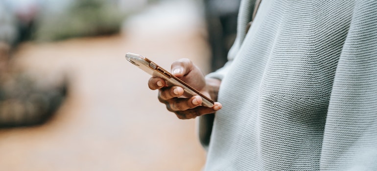 Close-up of a person checking the emails on their phone. 
