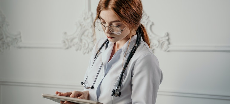 A healthcare worker in a rehab center, reading why addiction centers local SEO