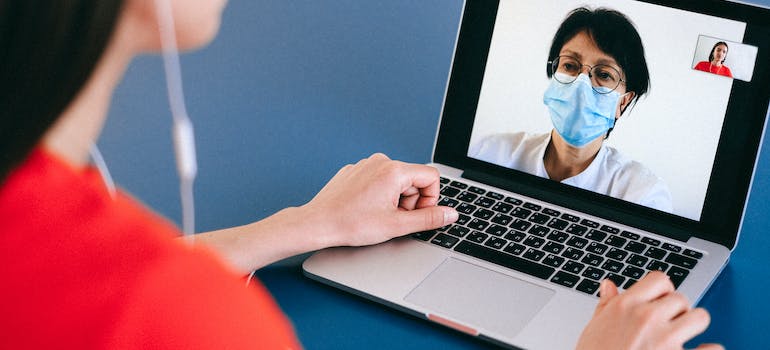 A doctor talking to a patient online, which is one of the 2024 healthcare marketing trends