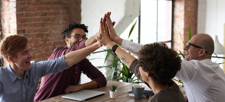 A group of people putting their hands together