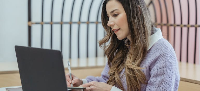 A person reading about the impact of marketing for long term recovery programs and taking notes