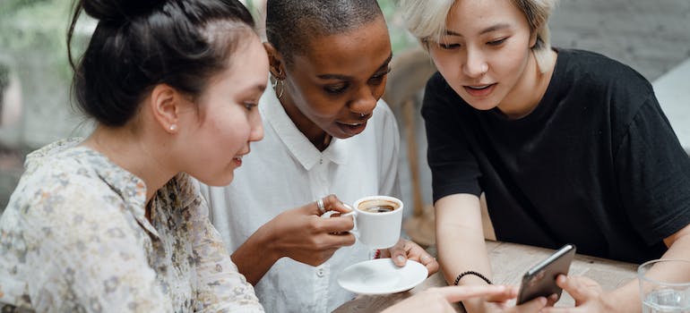 A group of friends reading customer reviews