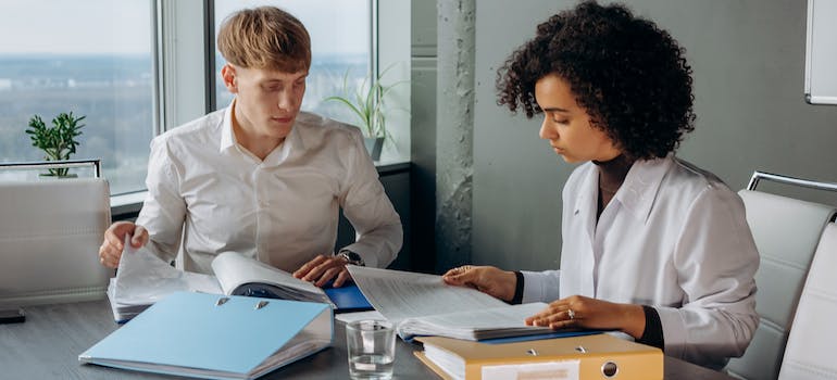 Two people going through plenty of regulations present in rehab marketing