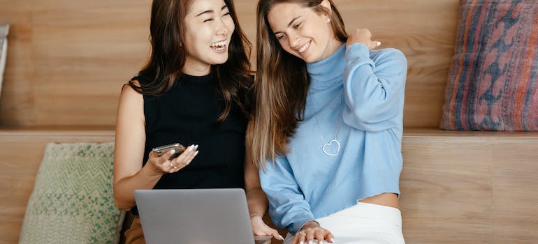 Two people happy about the simple checkout process, which is one the best practices to boost online shopping conversions