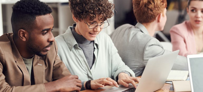 Two colleagues in a marketing company, discussing email marketing segmentation strategies