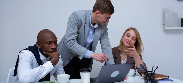 Colleagues talking about choosing the best addiction treatment keywords for Google Ads