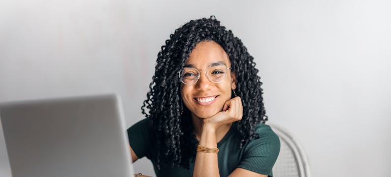 a woman working on her laptop and smiling