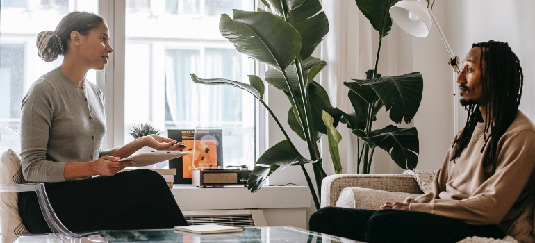 A woman and a man talking about ways to market your addiction treatment center to Millennials