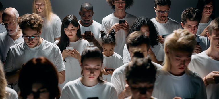 Many people staring at their phones 