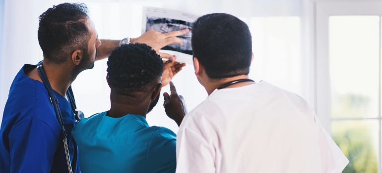 Three doctors looking at an x-ray