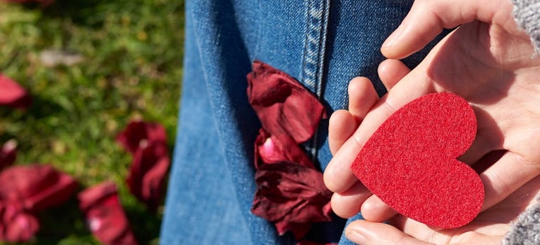 a person holding a flower-shaped cut out