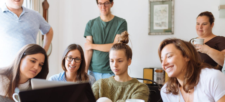 a group of people looking at a computer screen