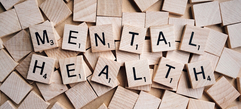 Scrabble tiles spelling "Mental Health" highlight the focus on successful mental health awareness campaigns.