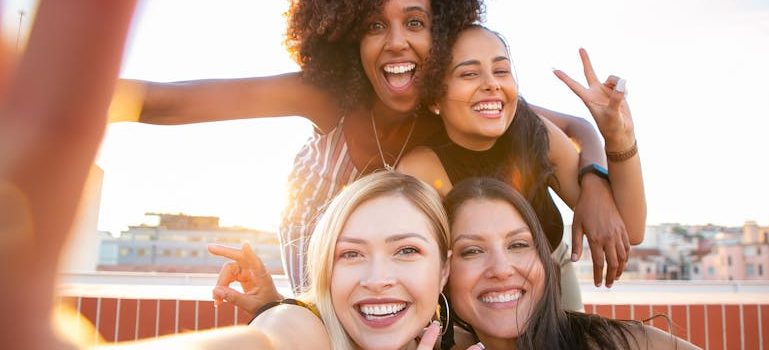 four happy girls smiling for a photo