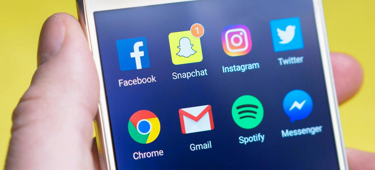 A smartphone screen displaying social media apps like Facebook, Instagram, and Twitter, which are essential tools for successful mental health awareness campaigns.