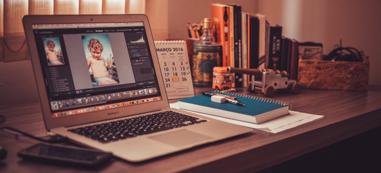 a working desk with a laptop and a notebook on it