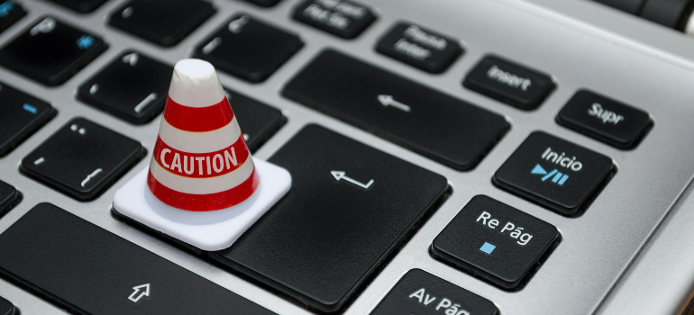 Caution cone on a keyboard symbolizing the importance of data privacy and ethics in digital marketing.