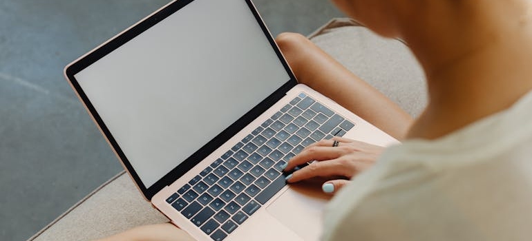 A person typing on their laptop