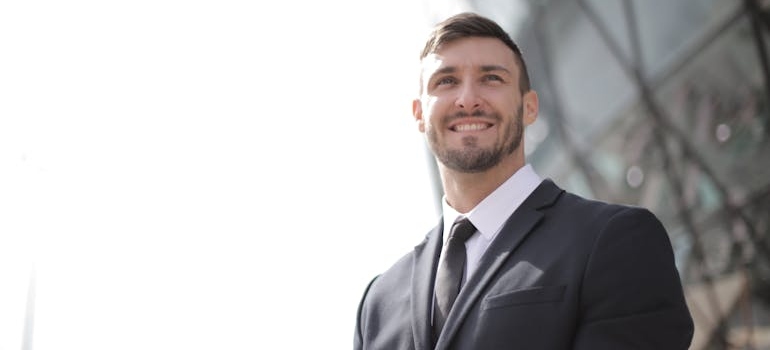 A man in a suit looking optimistic and content