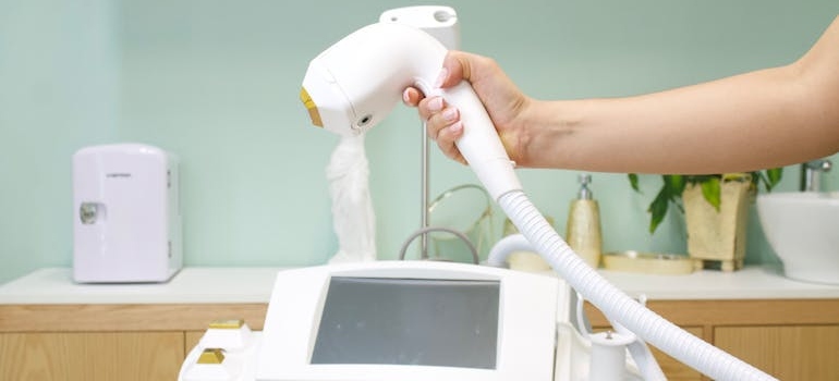 A person holding a comsetic machine