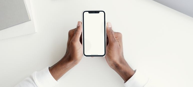 A person using a smartphone to search the Internet, which is why you need to have mobile-first web design