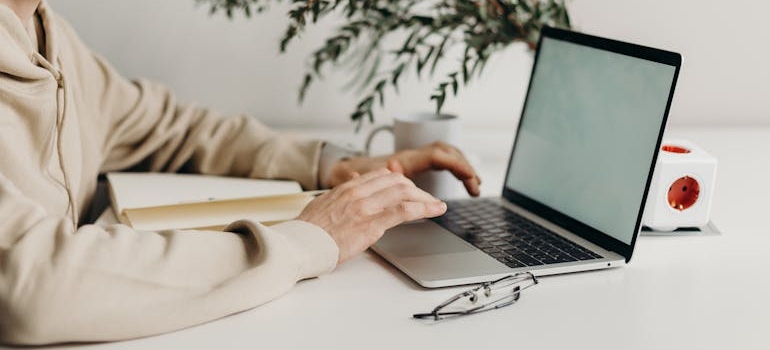 A person typing on a laptop