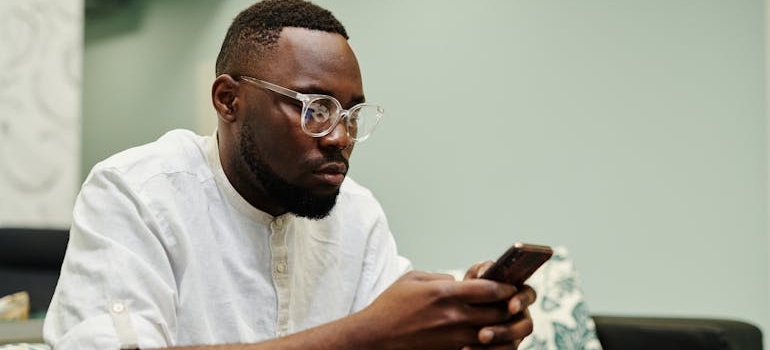 A person looking for FAQ on their smartphone, which is one of the blog topics every surgeon should cover on their website