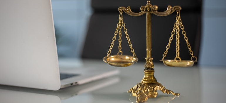 A golden balance scale on a desk