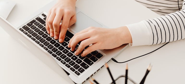 A person using a laptop to read and learn how to effectively market your med spa
