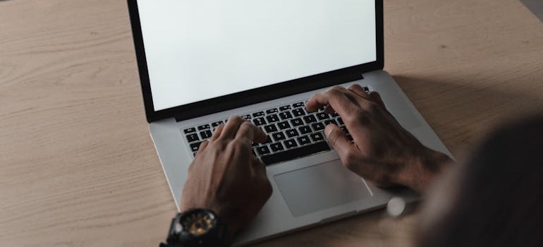 A person using a laptop to search and learn how to attract high-intent visitors to your rehab center