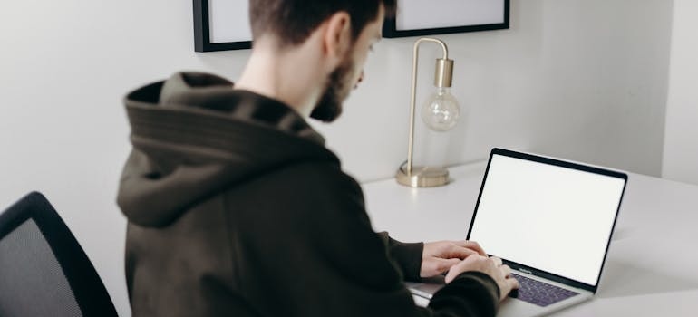 A person using a laptop to search for addiction centers