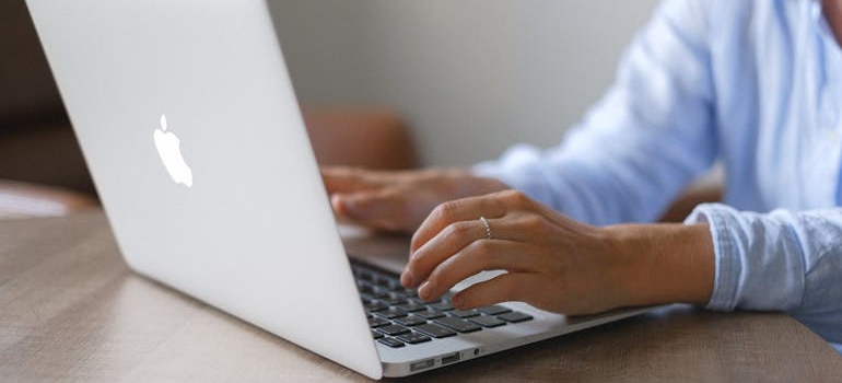 A person using a laptop to learn about New Year email campaigns for mental health clinics