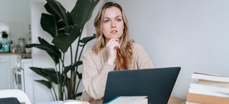 A person using a laptop to write about how local SEO puts your mental health clinic on the map