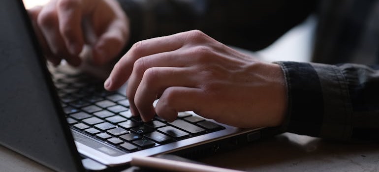 A person using a laptop tring to learn how to set up and verify your Google Business Profile in Dubai
