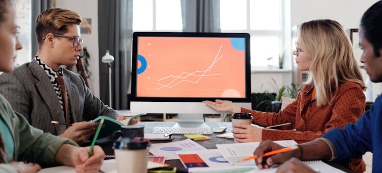 A group of experts looking at a graphic and discussing how local SEO puts your mental health clinic on the map