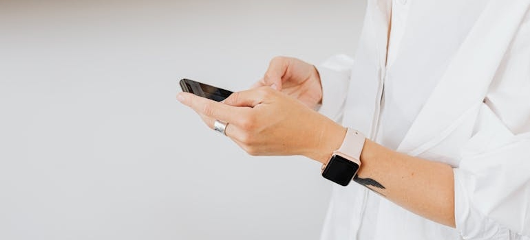 A person using a smartphone to explore aesthetic clinics